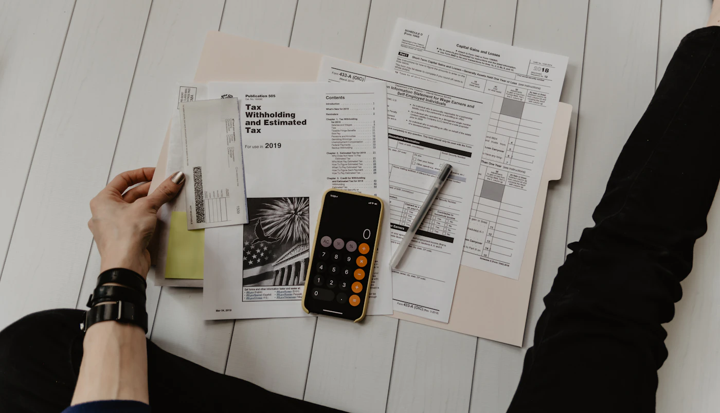 Financial statements and a calculator laid out on a desk